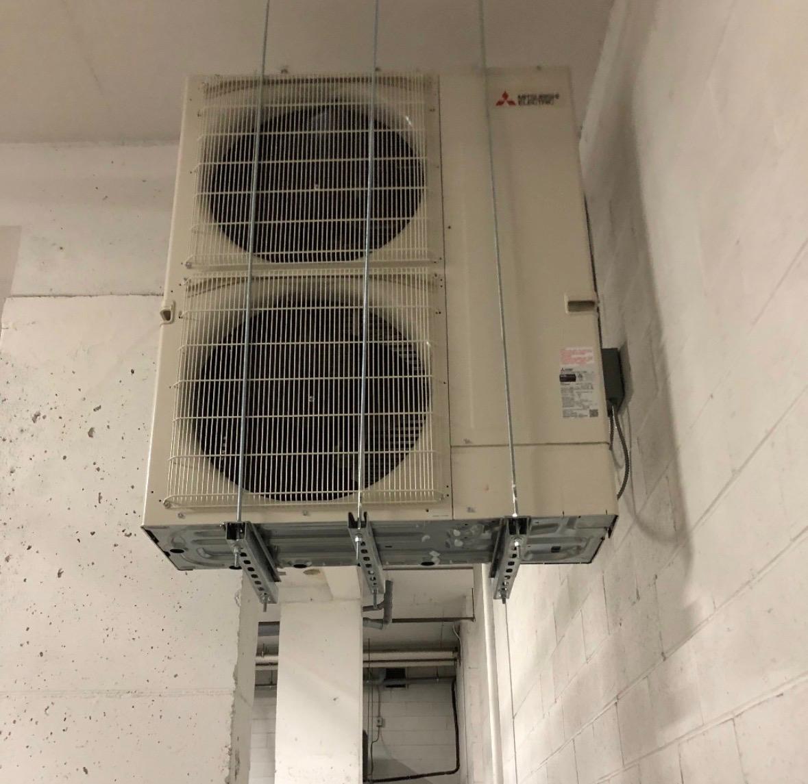 HVAC technician using a digital gauge to diagnose a system