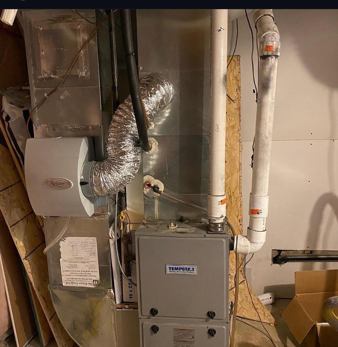 Technician servicing a high-efficiency residential furnace