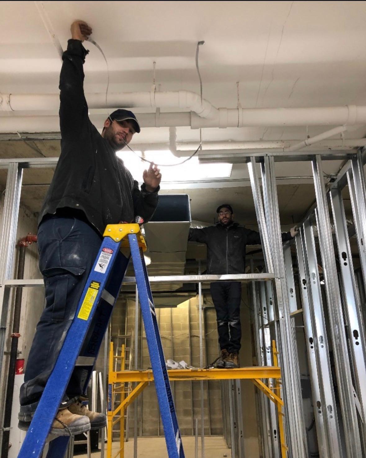 Alfa Energy technician installing an air conditioning unit at a Toronto home